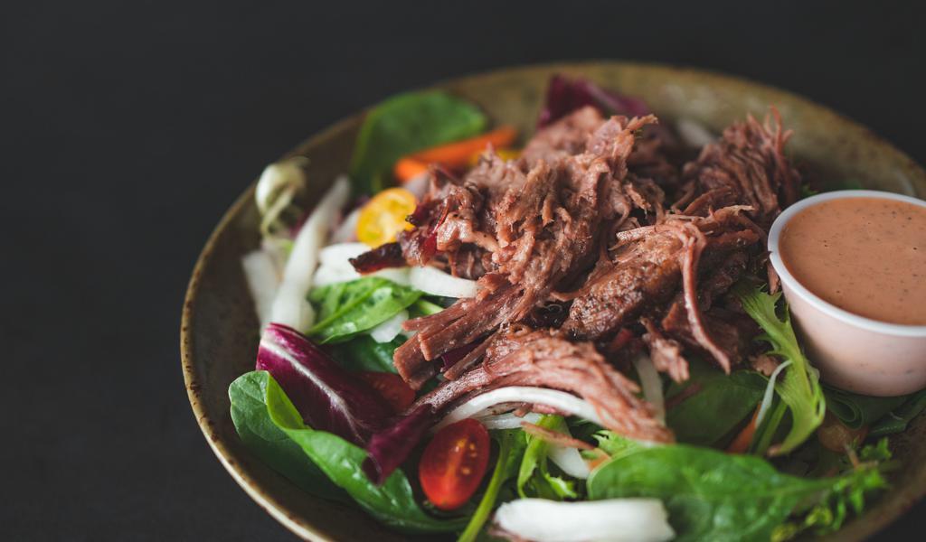 Smoked Brisket Salad · 18-hour smoked brisket, cherry tomatoes, thinly sliced onions, house Asian pickles, organic spring salad mix.