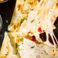Quesadilla · Grilled flour tortilla filled with melted cheese, onion & peppers served with guacamole, pic...