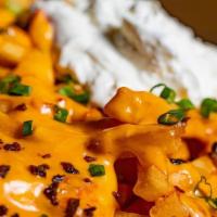 Loaded Fries · Topped with queso cheese, bacon, scallions & sour cream.