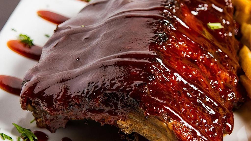 1/2 Rack Smoked Baby  Back Ribs · Slow roasted, seasoned & glazed with honey chipotle bbq sauce. Served with mashed potatoes, coleslaw, & pickle