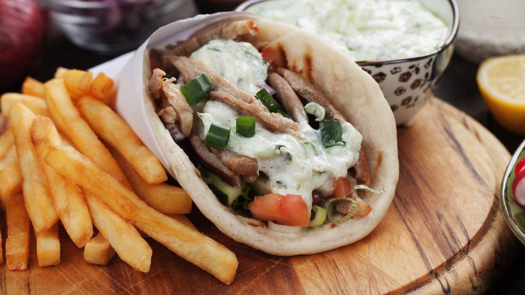 Lamb Gyro Wrap · Juicy lamb meat served with shredded lettuce, diced tomatoes, chopped onions and house made tzatziki sauce.