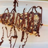 The Allergy Shot Cheesecake · New York cheesecake dipped in Ghirardelli milk chocolate Rolled in crushed hazelnut and driz...
