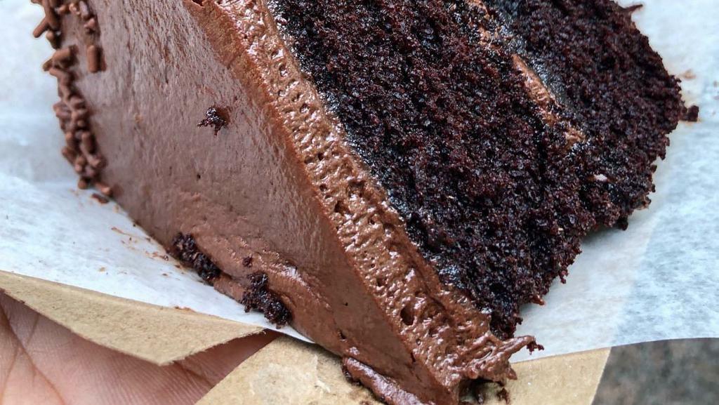 Chocolate Cake Slice · Layers of smooth chocolate cake covered in smooth chocolate buttercream.