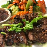 Tiger Cry Steak · Spicy. Grilled sirloin and steamed vegetables, with tamarind sauce. Served with jasmine rice.