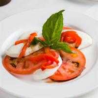 Insalata Caprese · Homemade mozzarella cheese with fresh tomatoes, roasted peppers and bassil.