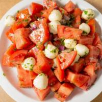 Italian Heirloom Tomato Salad · Heirloom tomatoes, fresh mozzarella balls and red onion with our homemade pesto dressing.
