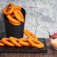 Onion Rings · Our thick-cut naturally sweet onion rings battered with a subtle blend of spices, fried gold...