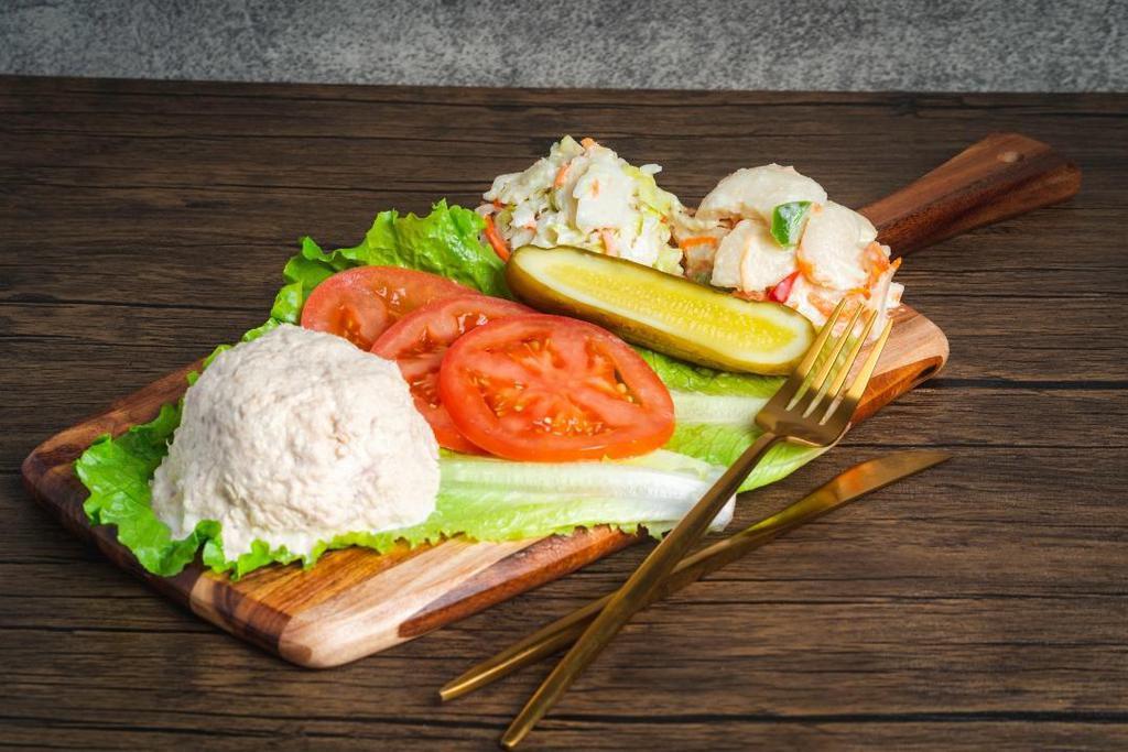 Tuna Salad · Tuna mixed with celery, mayonnaise and a hint of pepper. . Choose between a Sandwich or Plate. . The Tuna Salad Sandwich includes coleslaw and pickle on the side. . The Tuna Salad Plate includes bread, potato salad, coleslaw, lettuce, tomatoes and pickle.