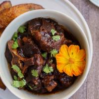 Oxtail Dinner · Brown Stewed Oxtails served with choice of rice, veggies, and a piece of plantain.