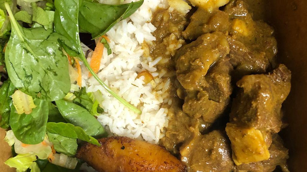 Curry Goat Dinner · Curried Goat served with choice of rice, veggies, and a piece of plantain.