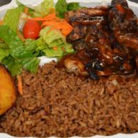 Jerk Pork Dinner · Marinated Jerk Pork served with choice of rice, veggies, and a piece of plantain. Comes with...
