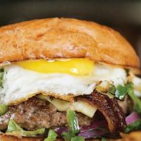 Texas Burger Deluxe · Beef patty, fried egg, swiss cheese, lettuce, pickles, and 1000 island dressing.