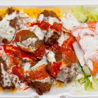 Falafel Over Rice · Rice , falafel , lettuce, tomatoes ,cucumber, white and hot sauce.