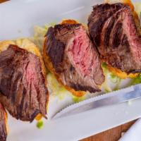 Steak Baguette Bites · Marinated skirt steak over toasted baguettes. Served with signature whiskey priest gravy.