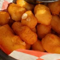 Wisconsin Cheese Curds · Golden brown deep-fried cheese curds served with spicy mayo & ranch dipping sauces.
