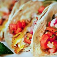 Fish Tacos · Three soft tacos with beer battered cod, lettuce, tomato, cheddar and avocado ranch sauce, s...