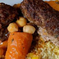 Couscous With Two Kofta Kebob · Steamed semolina grain served with kofta kebob, vegetable bouillon with carrots, sweet potat...