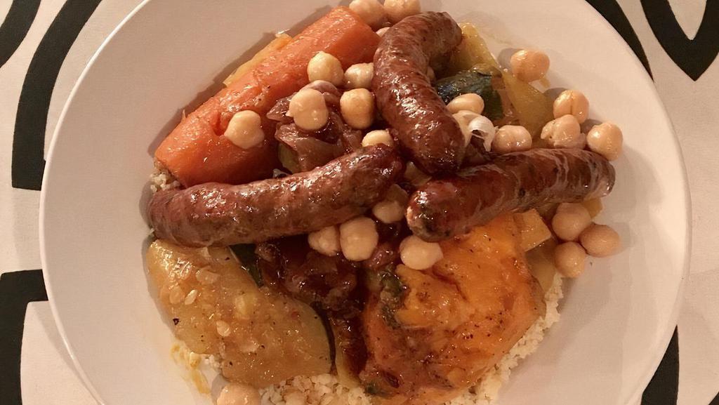 Veggie Couscous · Steamed semolina grain served with vegetable bouillon with carrots, sweet potato, zucchini, cabbage, caramelized onion and raisin.