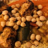 Couscous With Grilled Chicken Kebob · Steamed semolina grain served with grilled chicken kebob, vegetable bouillon with carrots, s...
