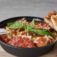 Polpettone · Meatballs in marinara served with a side of fresh made rosemary focaccia.