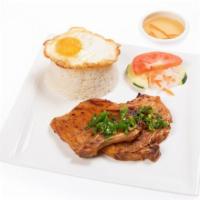 Grilled Lemongrass Pork Chop With White Rice · Spicy.  Gluten-free. Cucumber, tomato, pickle, carrot, and fried egg with fish sauce.