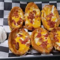 *Loaded Potato Skins · topped with cheddar cheese, bacon, served with sour cream