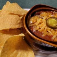 *Crock Homemade Chili · with cheddar cheese, jalapeño slice, corn tortilla chips
