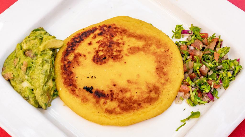 Yellow Arepa With Guacamole And Pico De Gallo · Cheese-filled corn patty served with guacamole and pico de gallo.