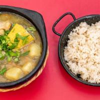 Sancocho · A hearty mix of chicken, potatoes, corn on the cob, plantains and yucca in a clear chicken b...