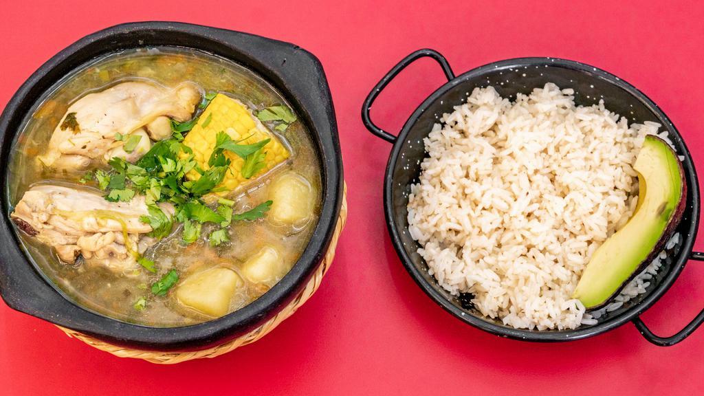 Sancocho · A hearty mix of chicken, potatoes, corn on the cob, plantains and yucca in a clear chicken broth.