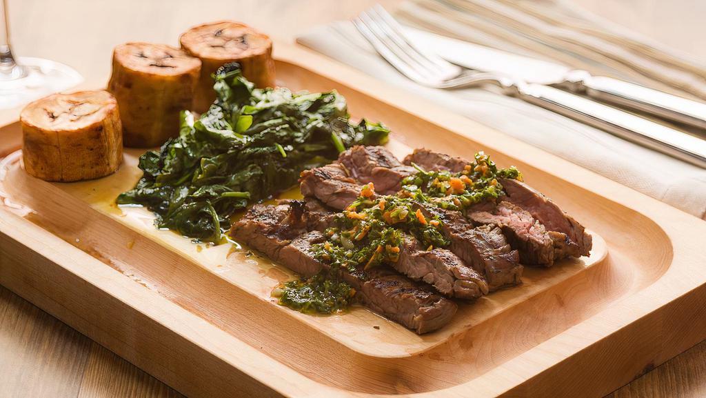 Carne Asada · Grilled eight oz flank steak topped with chimichurri sauce, served with sweet plantains and sautéed spinach.