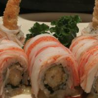 Maui  Roll · shrimp tempra  inside   topped with kani  eel sauce  and coconut sauce .