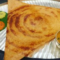 Onion Dosa · Thin rice and lentil crepe topped with onions. Served with three varieties of chutneys and s...
