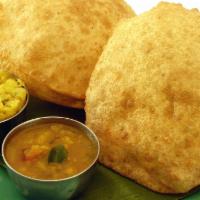 Poori · Fried fluffy whole wheat bread served with two curries.
