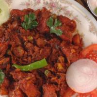 Kaima Idly · Deep fried mini idly sauteed in regional spices served with raitha.