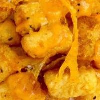 Cheesy Tots · Cheddar Cheese melted over seasoned Tots.