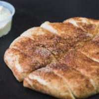 Cinnamon Stix · Cinnamon Sugar Dusted on top of bite sized D.P. Dough Stix, served with a side of vanilla fr...