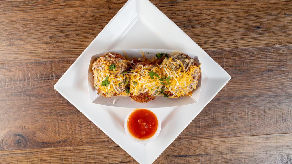 Fried Mac Balls · Our Instagram Famous Fried Mac & Cheese Balls. Three handmade fried Mac and Cheese balls smothered in homemade cheese sauce.