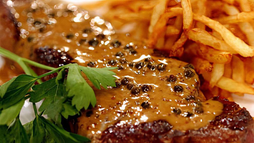 Steak Au Poivre · Certified black angus NY strip steak, confit broccoli, ultimate crispy fries, green peppercorns, Hennessy VSOP cream sauce.
