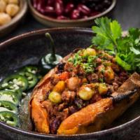 Loaded Sweet Potato · Cal:440 C:89 P:18 F:3 - Spiced five-bean chili with fresh jalapeños on a crispy, baked sweet...
