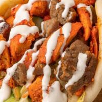 Mixed Gyro · Served on a warm pita with Chicken and Lamb topped with shredded lettuce, our chopped Greek ...