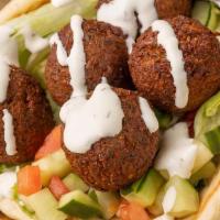 Falafel Gyro · Served on a warm pita with Falafel and topped with shredded lettuce, our chopped Greek Salad...