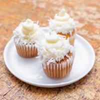 Coconut Cupcakes · Light and airy toasted coconut cake topped with coconut cream cheese frosting and shredded c...