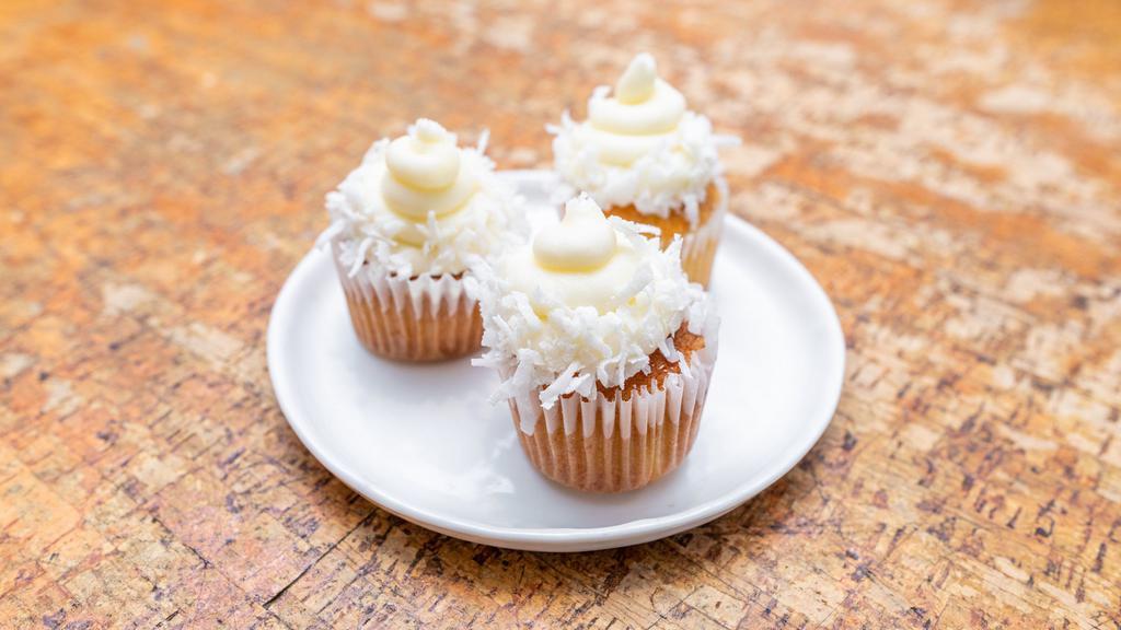 Coconut Cupcakes · Light and airy toasted coconut cake topped with coconut cream cheese frosting and shredded coconut.