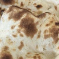 Garlic Naan · Made with white flour mix with milk & salt coated with butter & garlic cooked in charcoal ov...