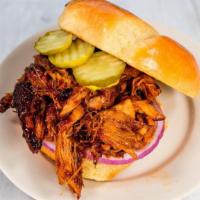 Pulled Pork Sandwich · chipotle citrus BBQ sauce, dill pickle, red onion on pretzel bun