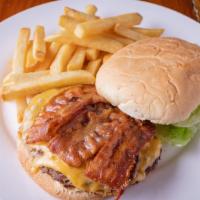 Cheeseburger Deluxe · Topped with lettuce and tomato. Served with French fries and a pickle.