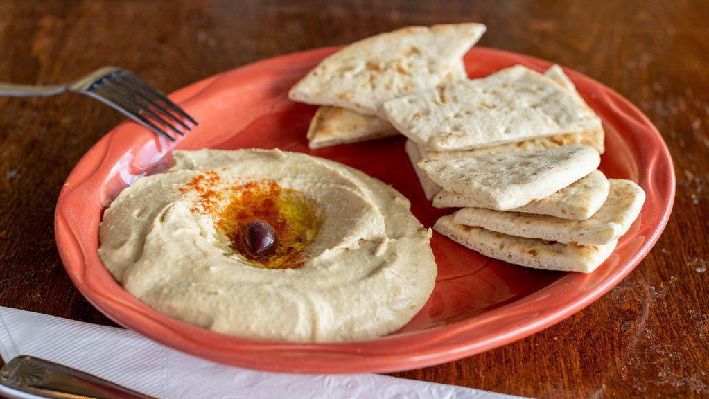 Hummus · Served with chopped parsley, tomato, paprika, and olive oil.