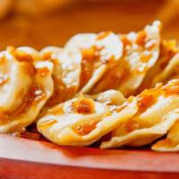 Sauerkraut Pierogi (Package) · These homemade Polish dumplings are stuffed with sauerkraut and spices in a hand-rolled soft...
