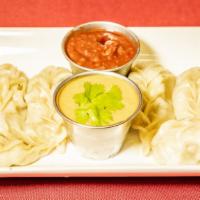 Steam Chicken Momo · Minced chicken wrapped in pastry served with tomato and sesame seed achar